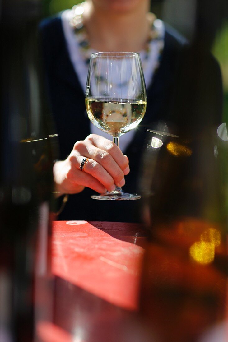 A woman holding a wine glass at a wine festival
