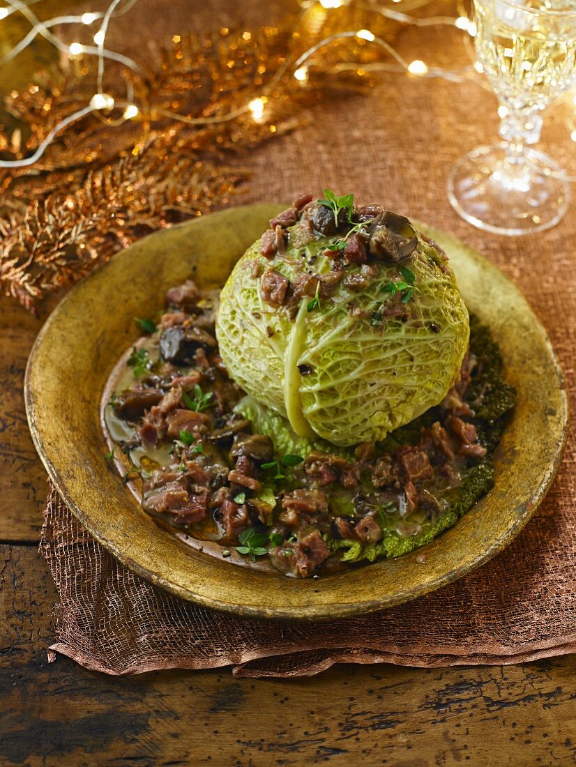 A braised savoy cabbage head garnished for Christmas