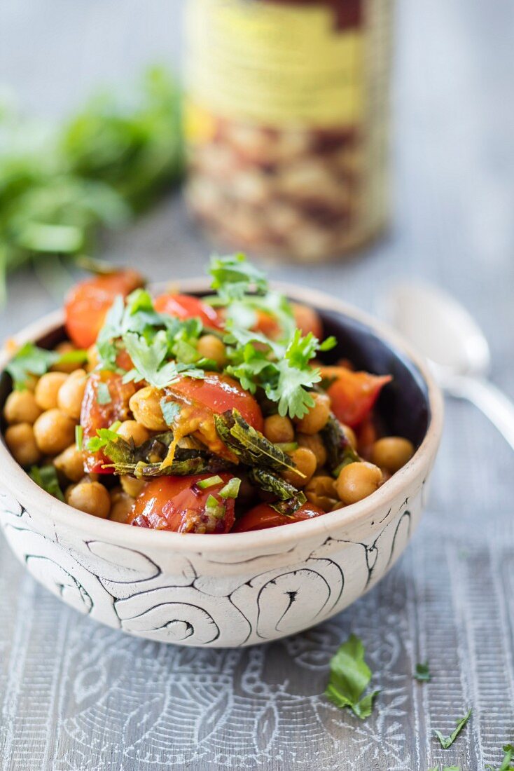 A chickpea bowl with cherry tomatoes and curry leaves