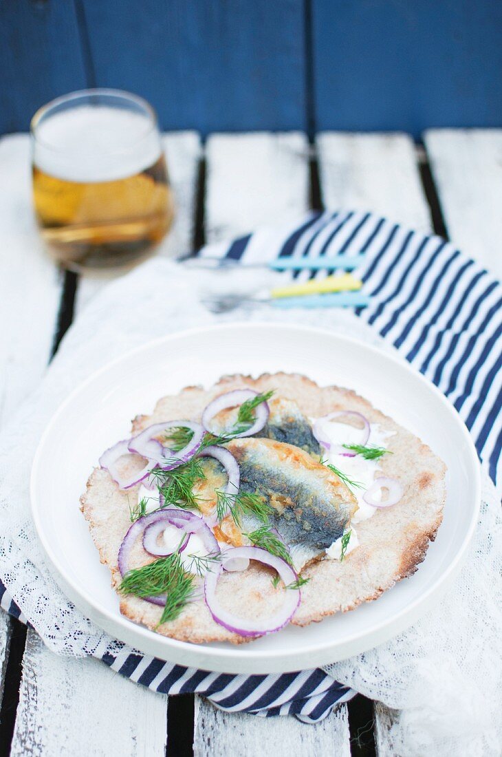 Fried herring with homemade crispbread, sour cream, red onion and fresh dill (Swedish street food)
