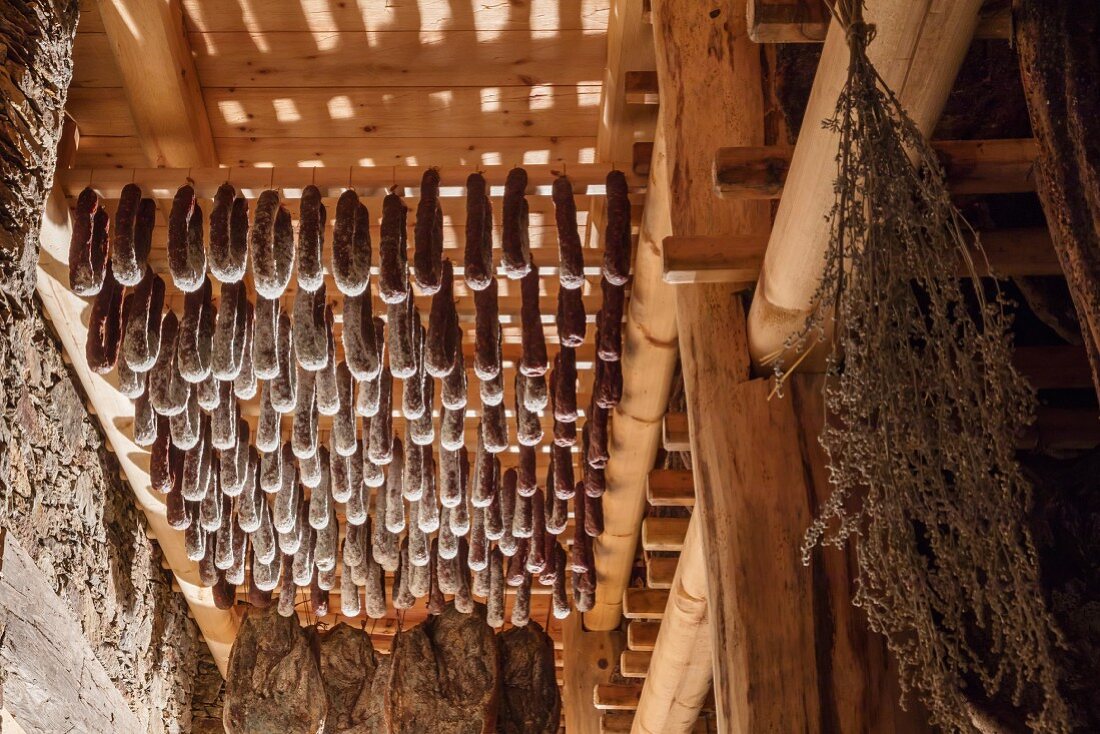 Bacon and sausages in the curing chamber at the Hofmanufaktur Kral in South Tyrol