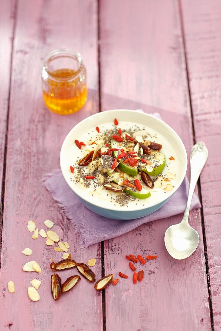 Almond milk soup with pear, almond flakes, goji berries and dates