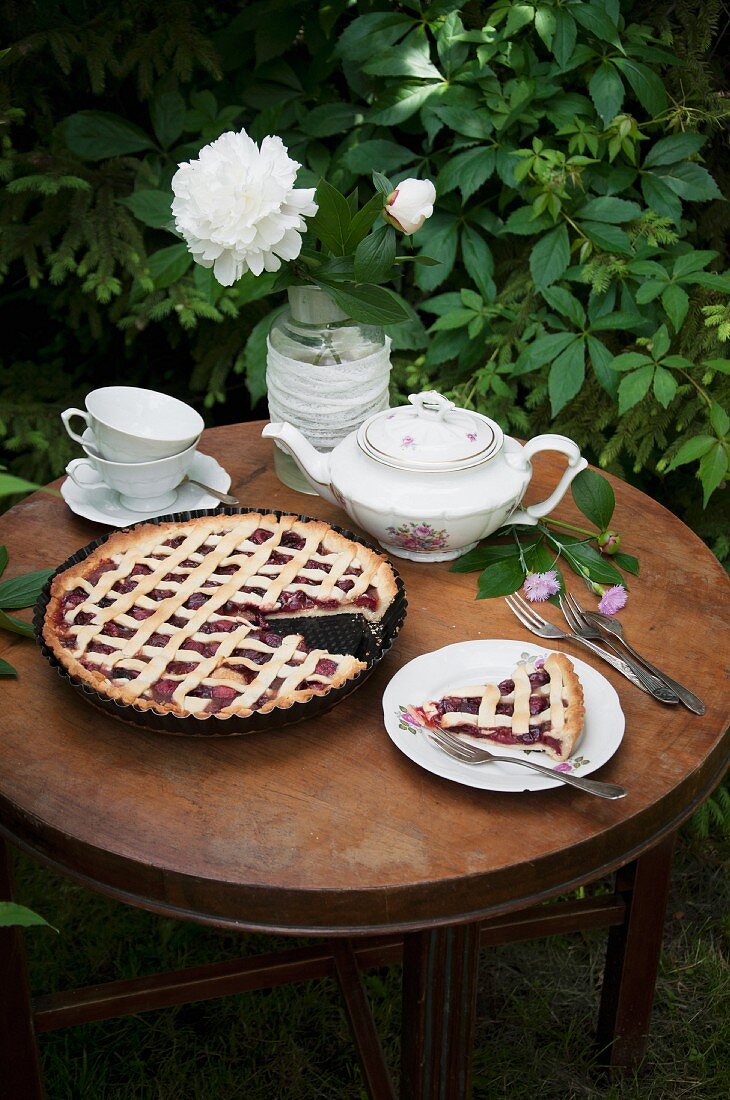 Cherry lattice pie served on a garden table