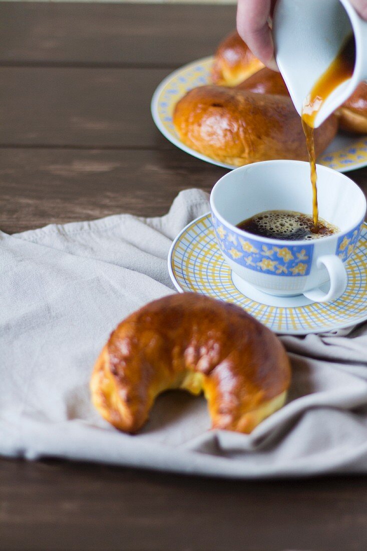 Crescent-shaped walnut pastries served with a cup of coffee