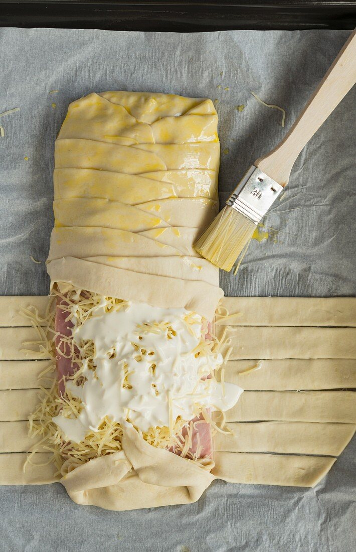 Unbaked puff pastry with ham and cheese