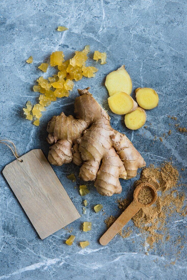 Different types of ginger, fresh, grounded and candied, view from above