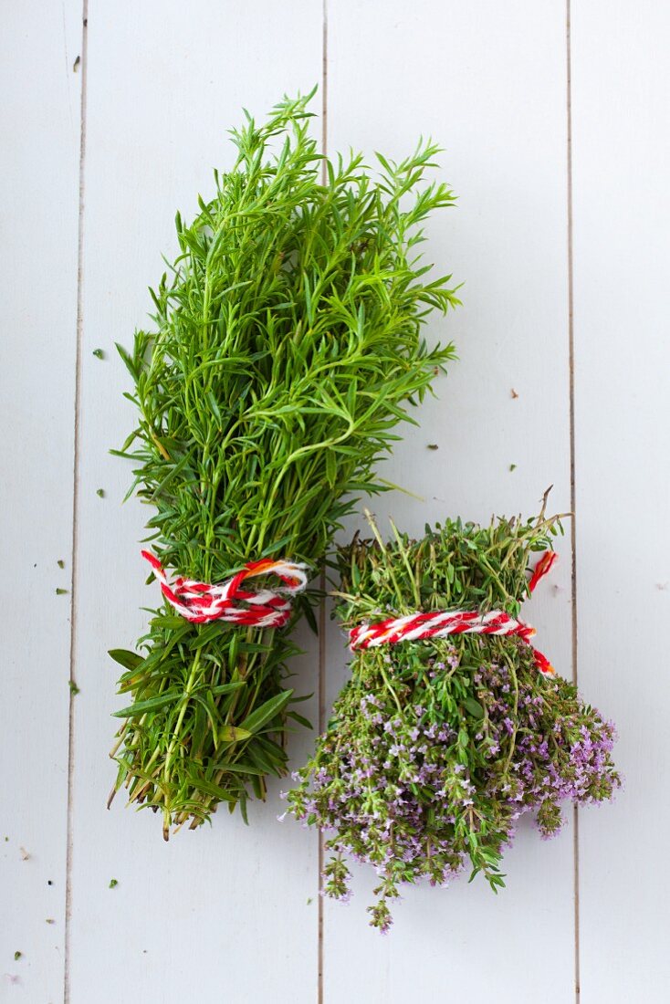 Bunches of fresh tarragon and thyme tied with striped twine