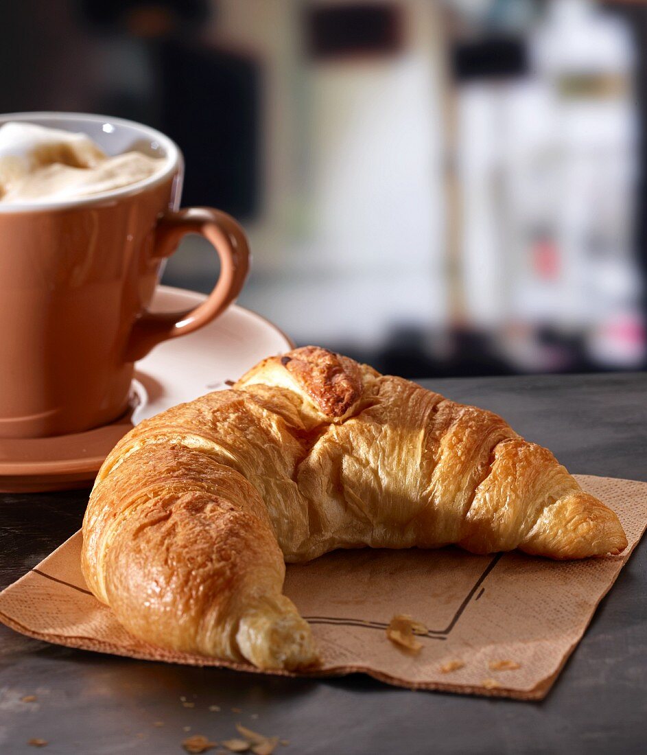 A croissant with a latte in a cafe