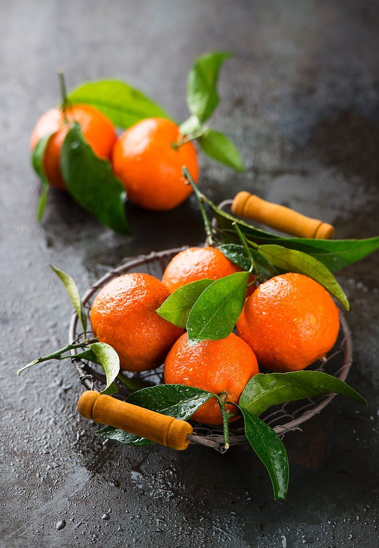 Tangerines with leaves in a basket