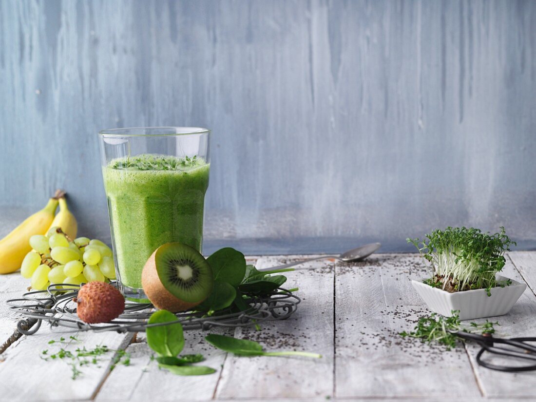 Green fitness smoothie with fruit and herbs