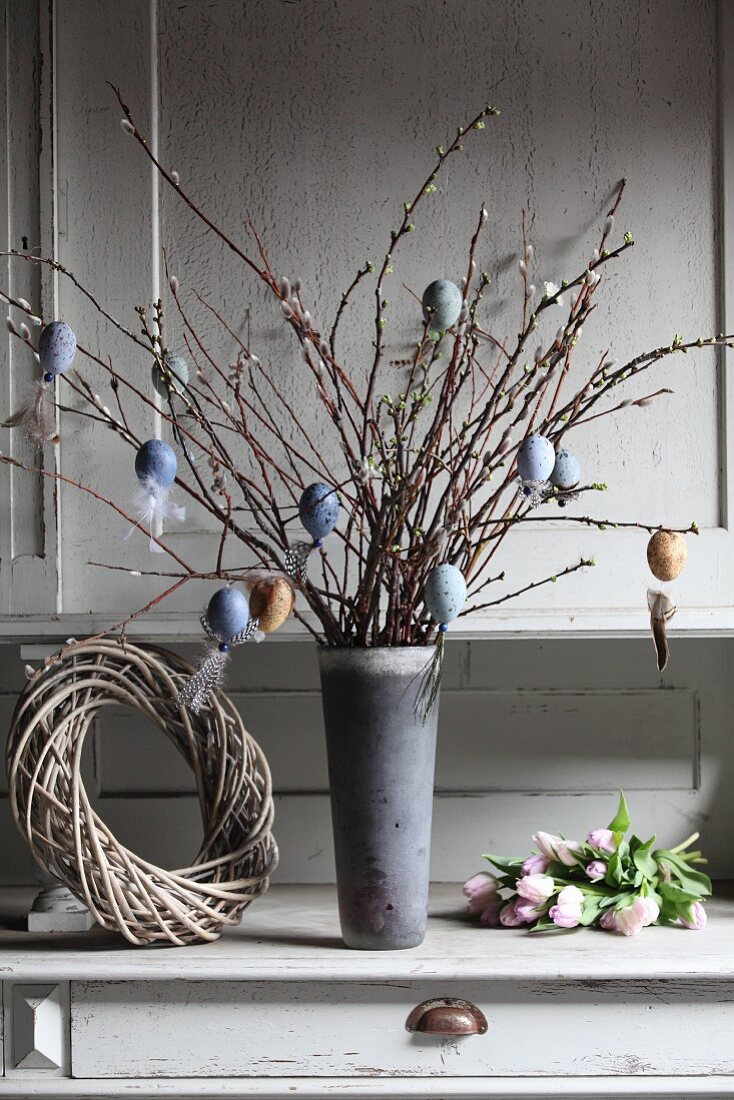 Hand-made Easter decorations hung from branches of pussy willow