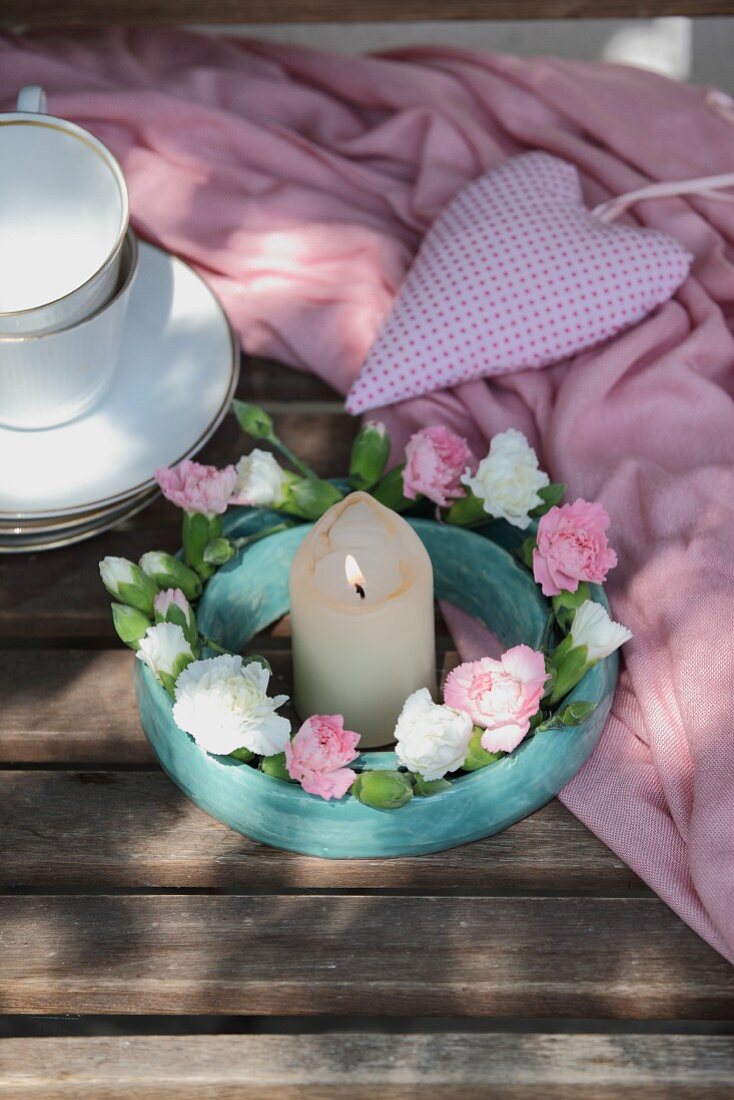 Wreath of carnations around candle