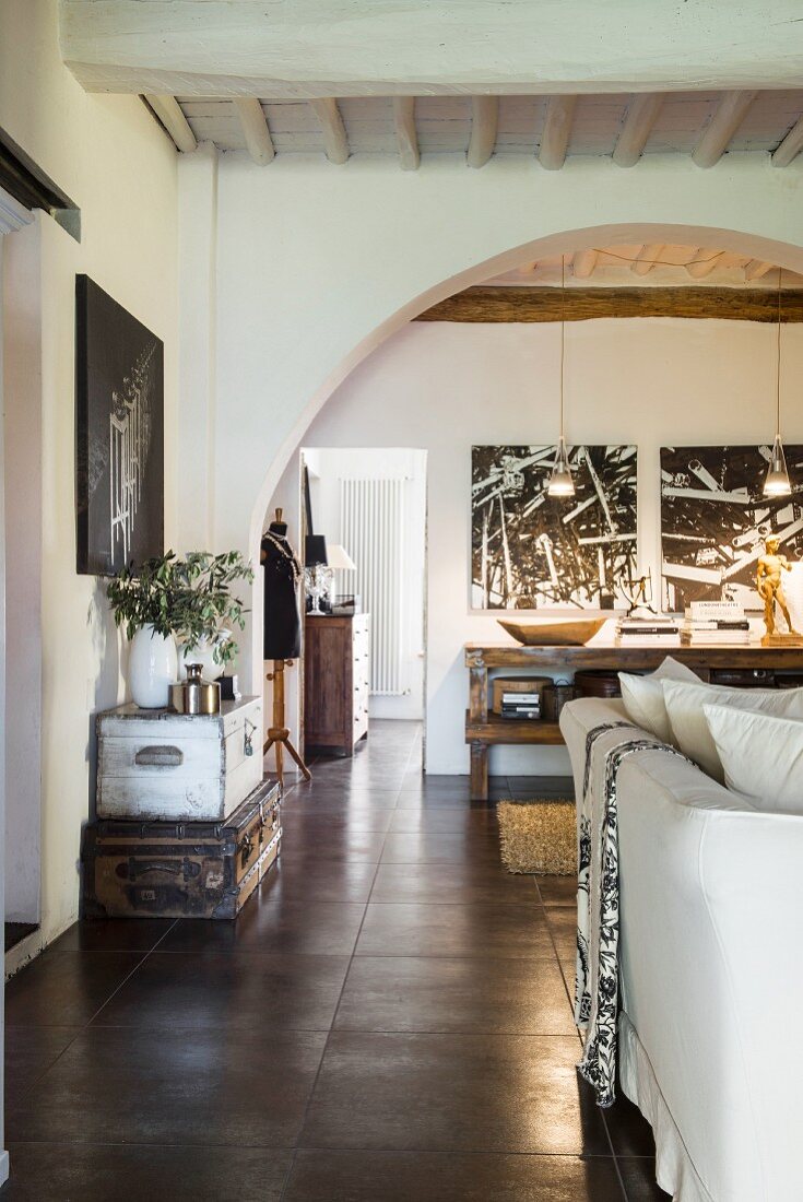 Open-plan interior of converted wine cellar with wood-beamed ceiling