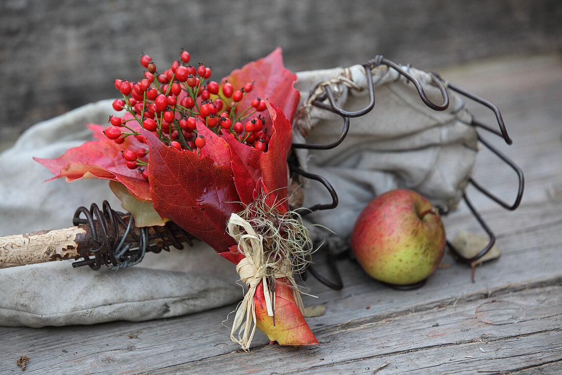 Posy of small rose hips and red Virginia creeper leaves