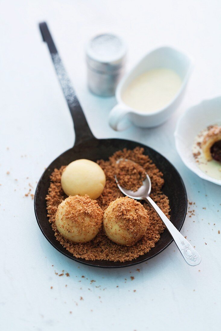 Damson dumplings with buttered crumbs