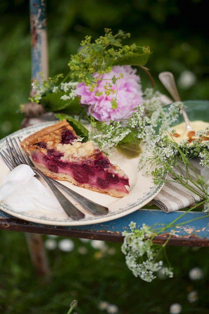 Cake, pudding and flowers on chair for garden picnic