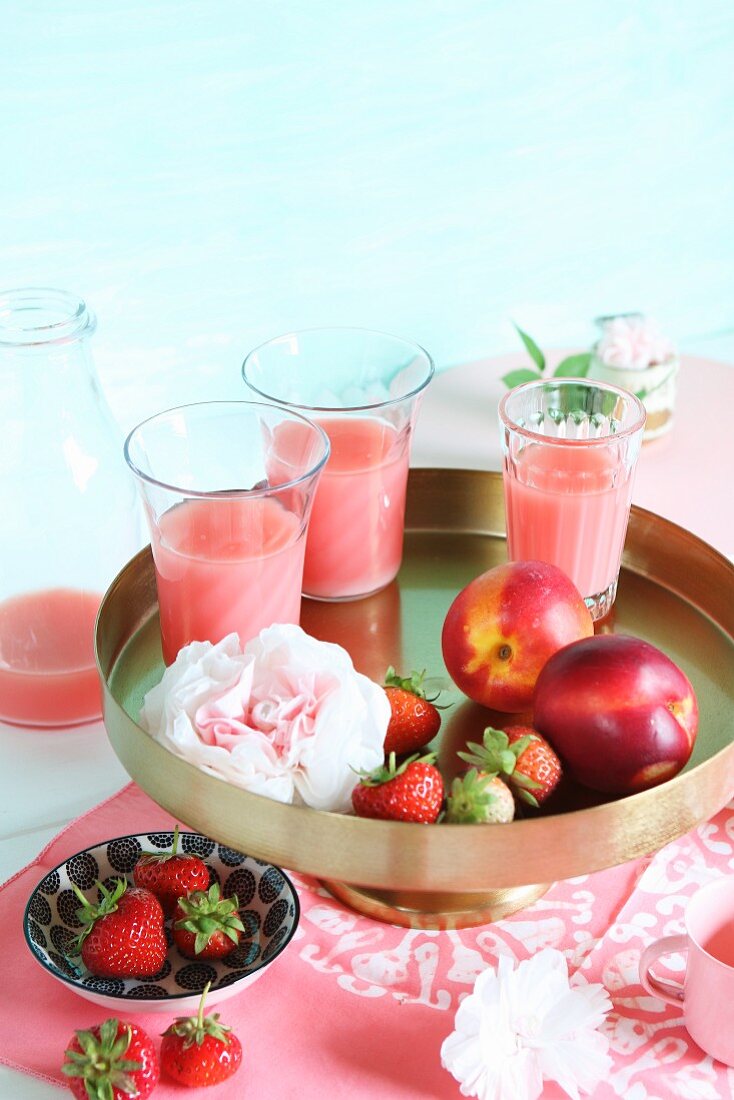 Strawberry and nectarine smoothies on a golden stand