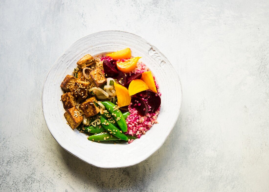 Pickled golden and red beets tossed with quinoa, topped with grilled tofu and sugar snap peas