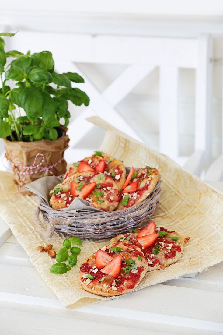Small strawberry pizzas on a wooden table
