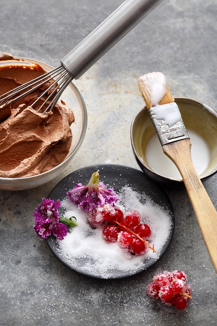 Cake decorations: chocolate cream, sugar icing, sugared berries and flowers