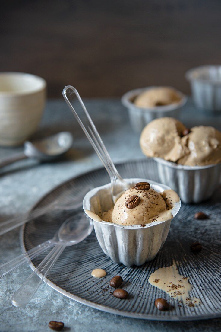 Coffee ice cream with coffee beans in metal cups