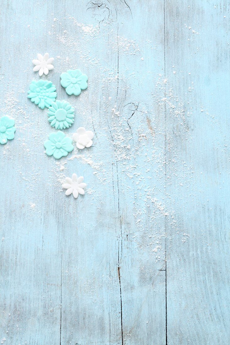 Fondant flowers on a light blue wooden background