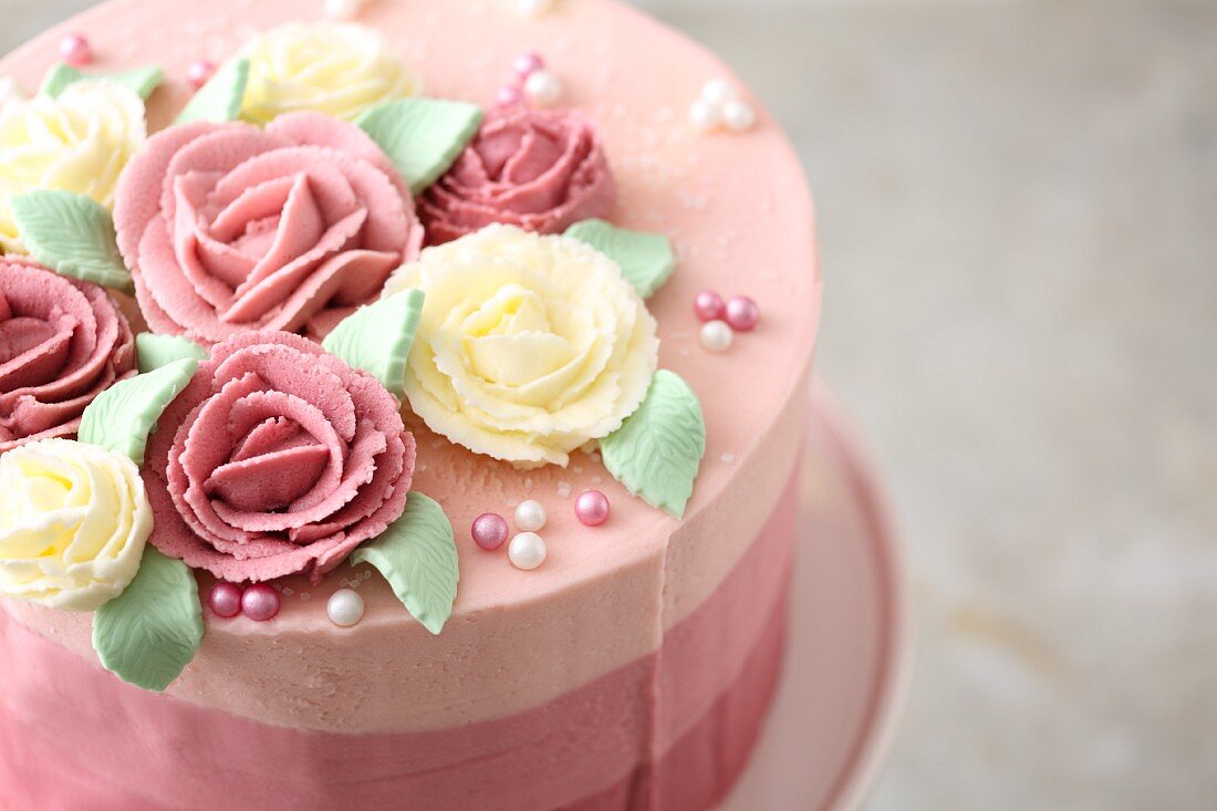 Striped ombre cake decorated with buttercream roses