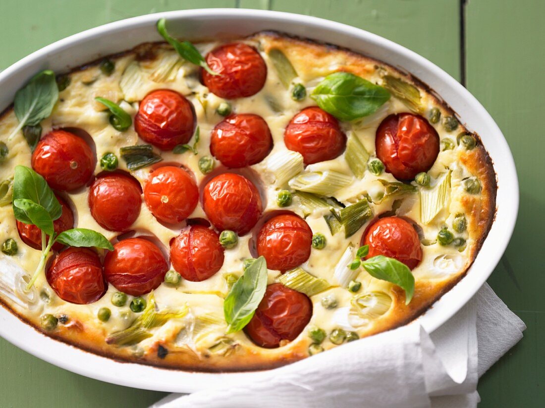 Clafoutis with tomatoes, peas, ricotta and basil