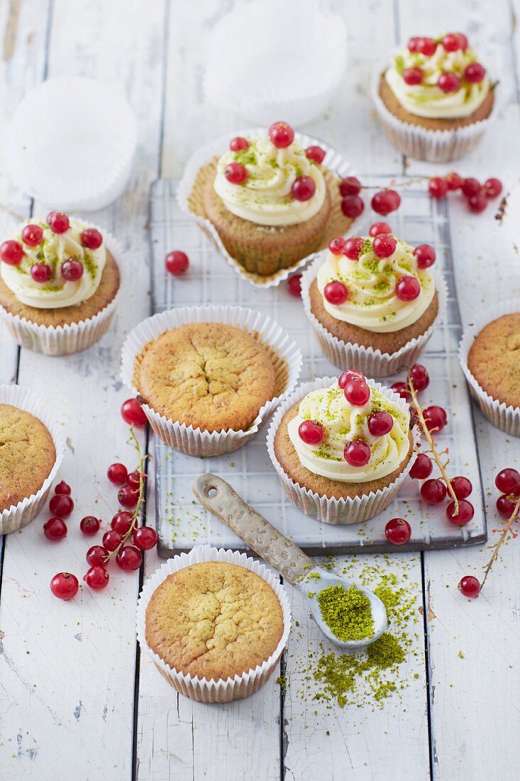 Pistachio cupcakes with honey buttercream and redcurrants