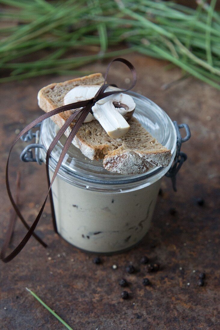 Hearty wild mushroom soup with potatoes in a glass jar