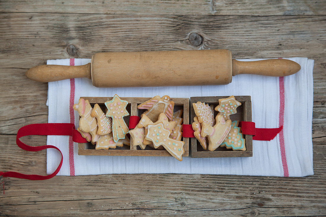 Gingerbread biscuits in wooden boxes with a rolling pin