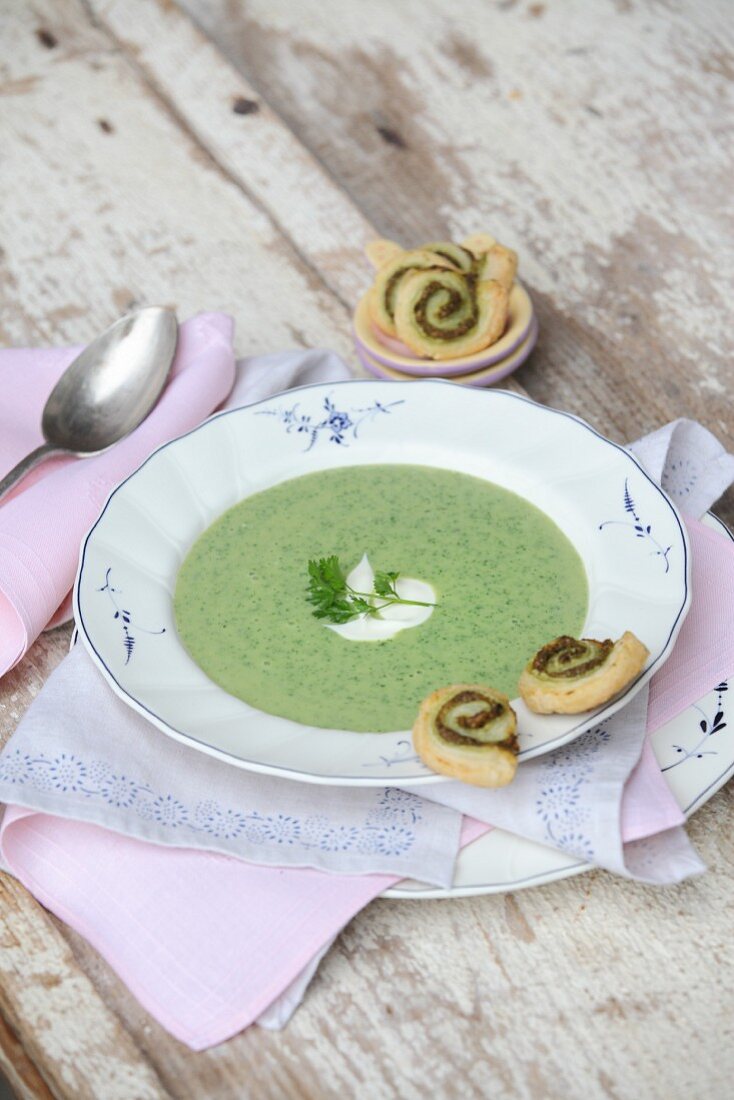 Cream soup with herbs and puff pastry whirls
