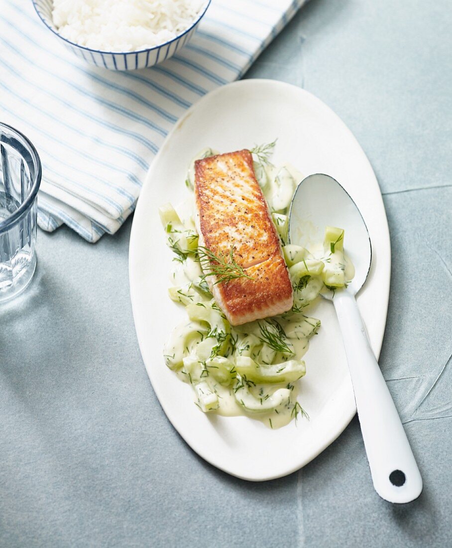 Fried fillet of salmon on stewed cucumber with dill
