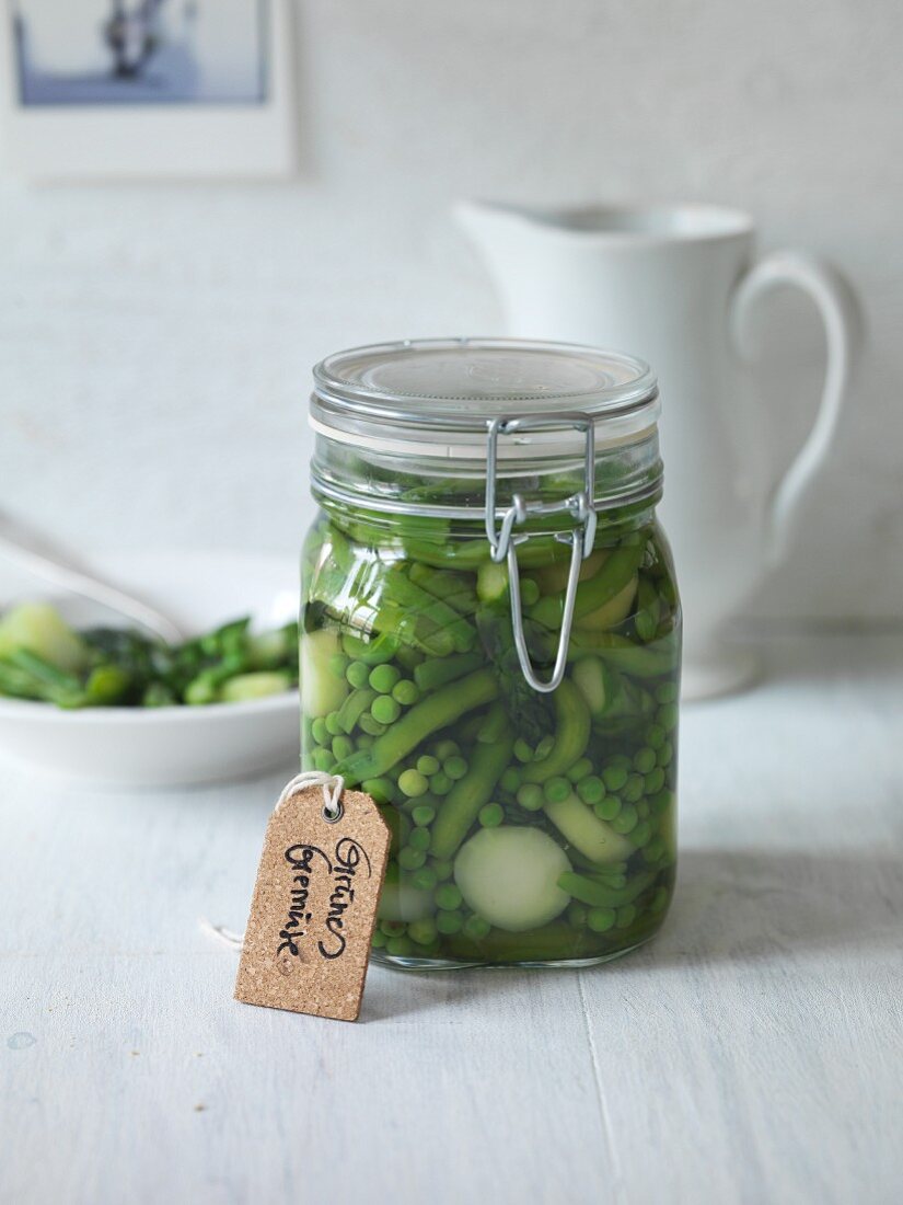 Preserved green vegetables in a storage jar