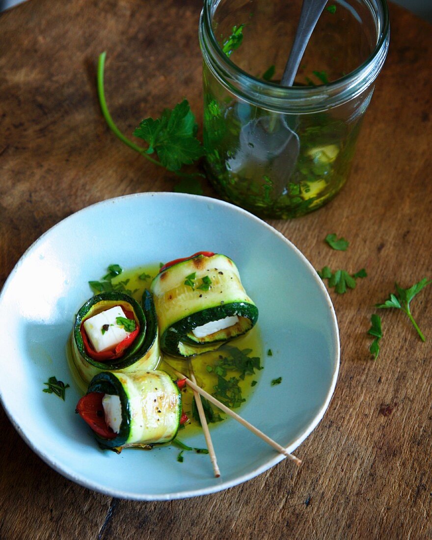 Gegrillte Zucchini-Feta-Röllchen in Olivenöl eingelegt