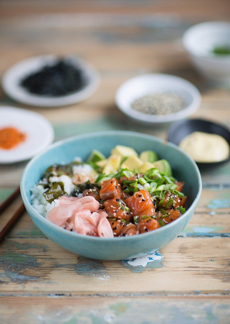 Salmon poke with avocado, spring onions and rice