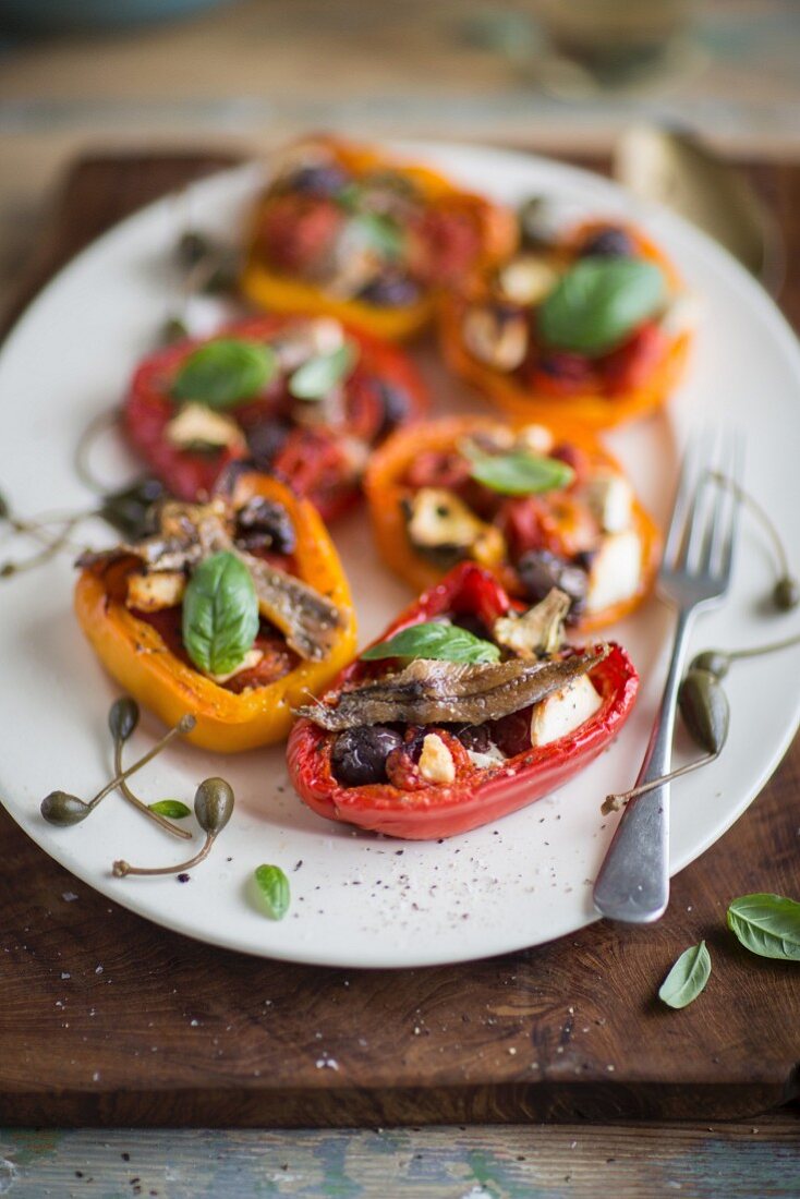 Stuffed pepper halves with anchovies, olives and capers