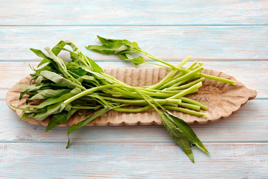Water spinach in a wooden bowl