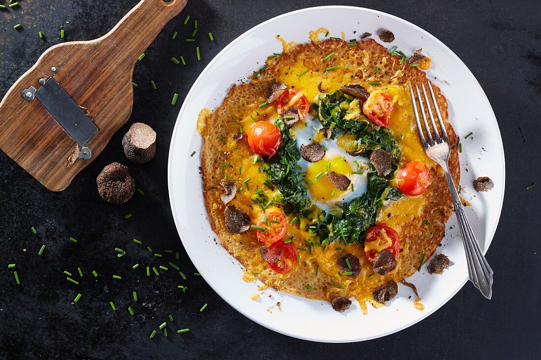 A galette with truffle, tomatoes and a poached egg