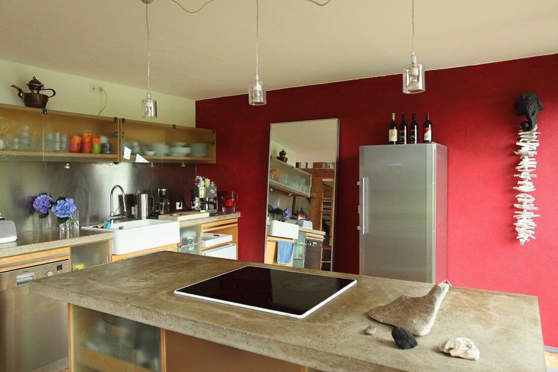 Island counter and red wall in kitchen