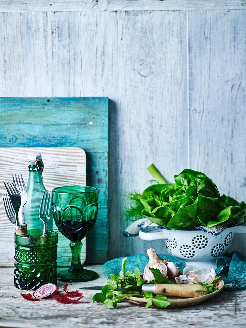 Stillleben mit Salat, Knoblauch und Glas Rotwein
