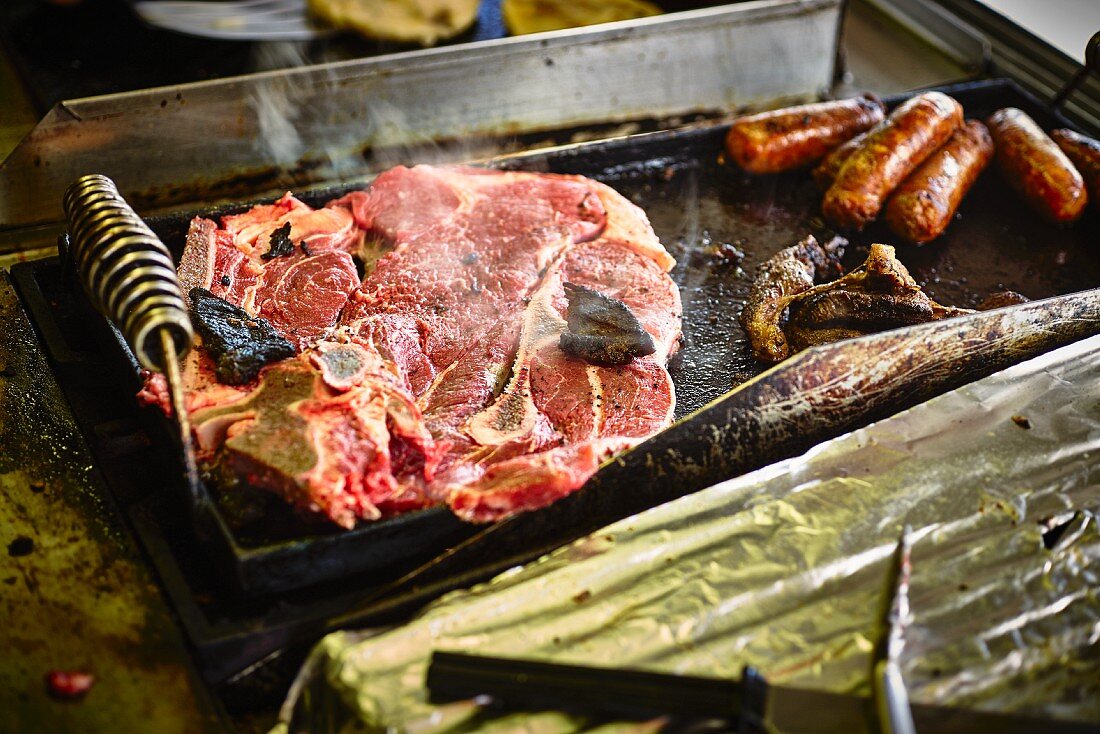 Ribeye steak on the grill in a street kitchen (USA)