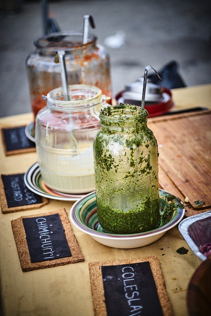 Chimichurri sauce in glass in a street kitchen