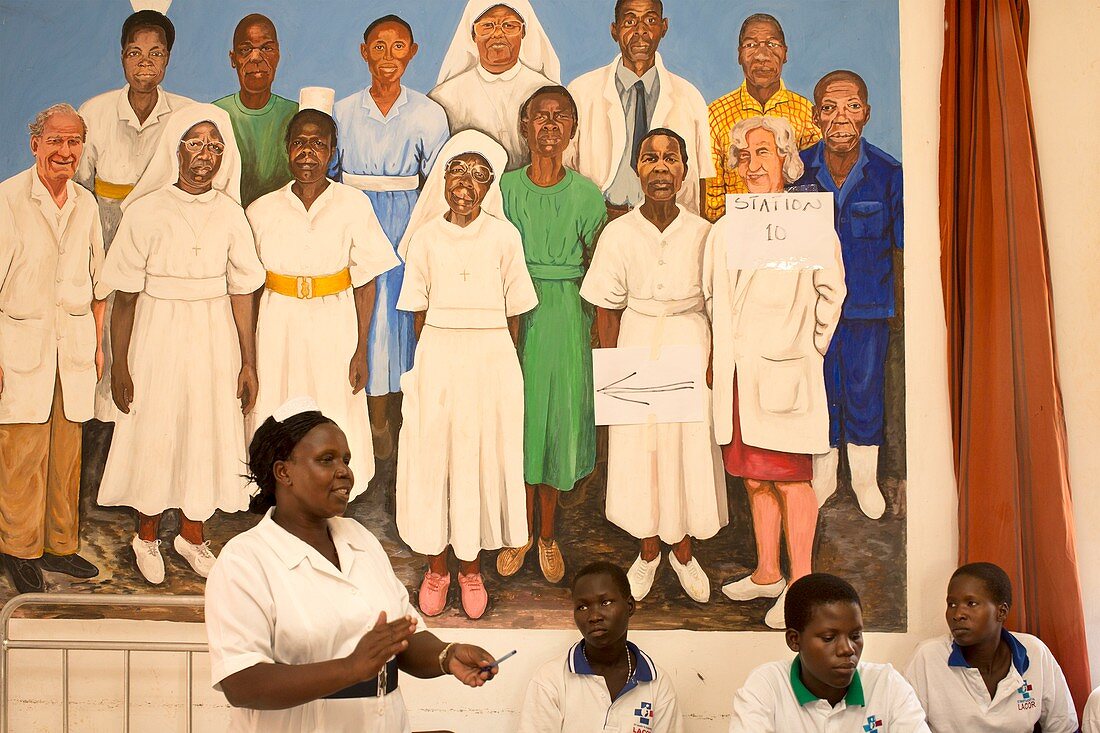 Teacher and students with hospital mural