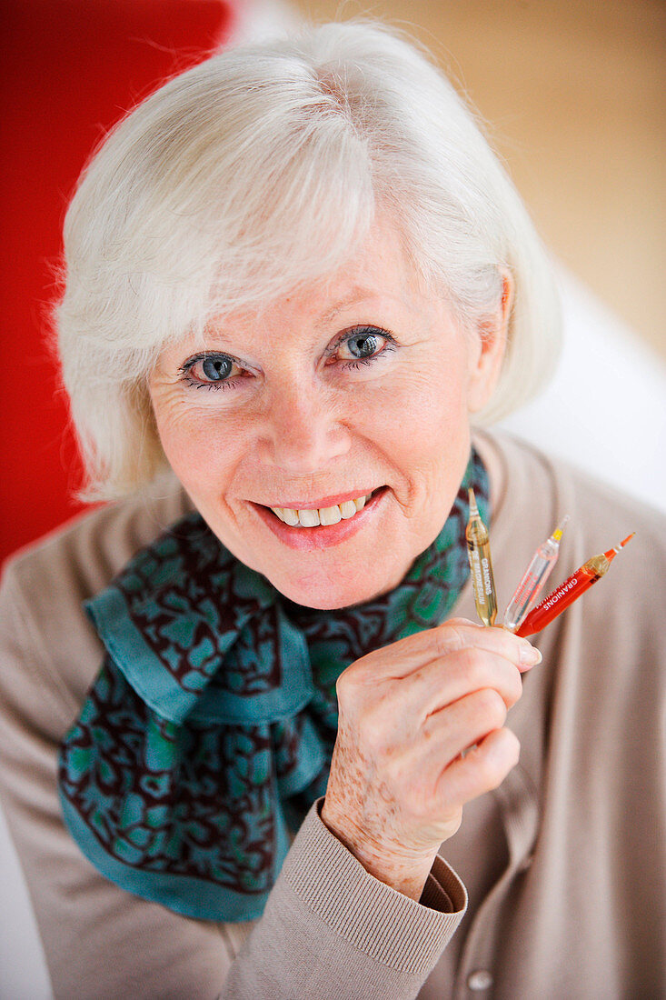 Woman holding a glass ampoule