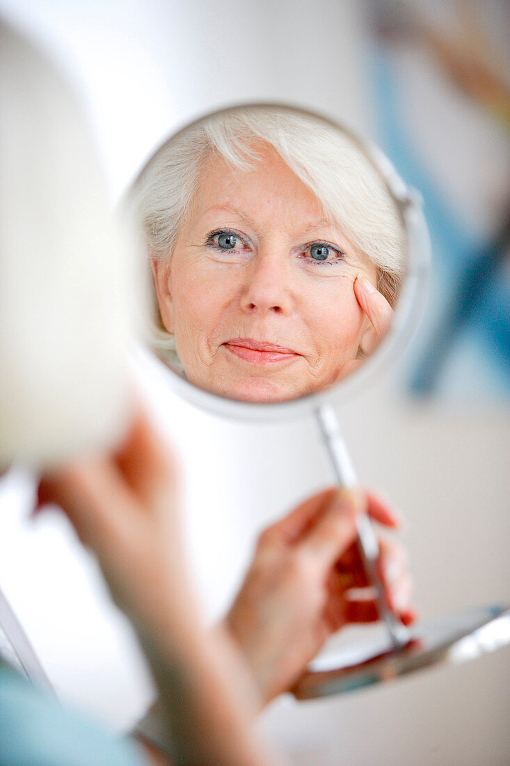 Senior woman at the mirror