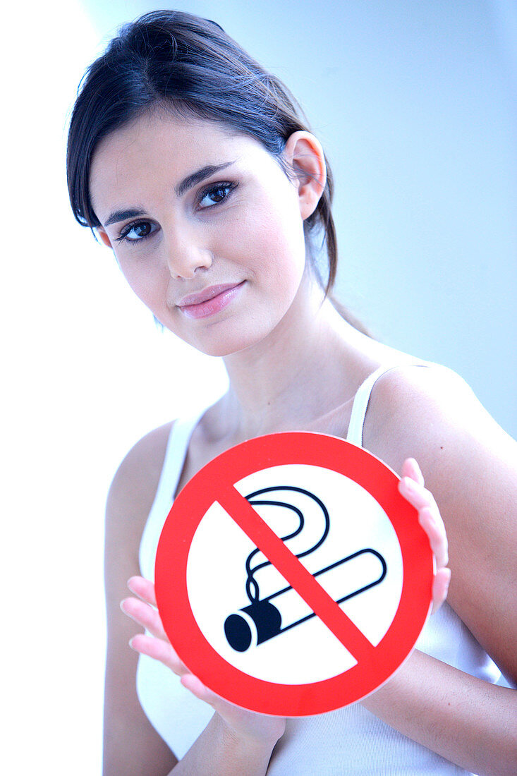 Woman with a No smoking sign