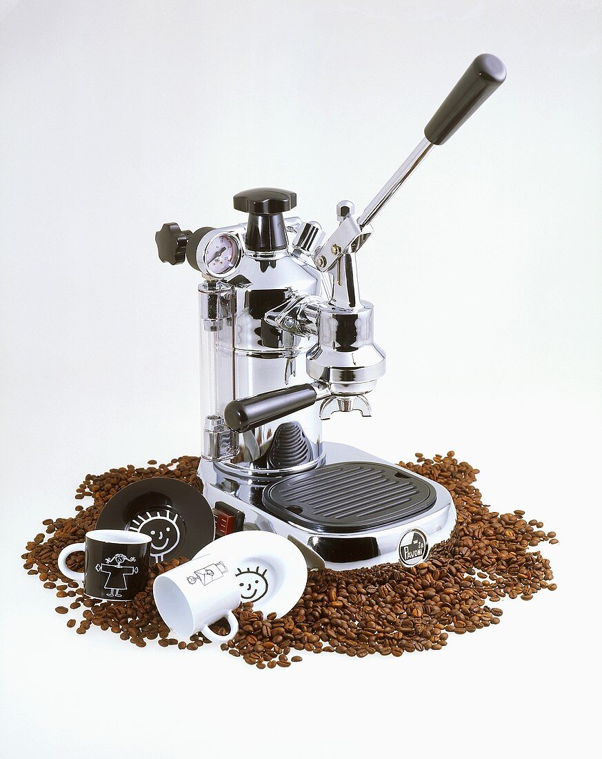 Espresso Machine and Two Cups Surrounded by Coffee Beans