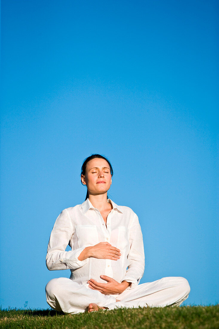 Pregnant woman practising yoga