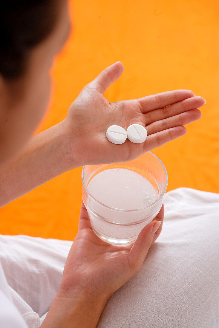 Woman taking an effervescent tablet